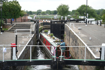Nottingham, England - June 20 2025: Narrowboat navigating Beeston Lock on a serene summer day