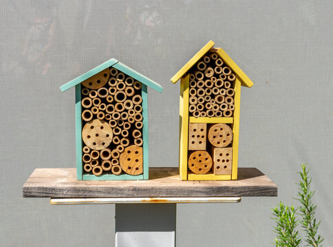 Turquoise and Yellow Wooden House-Shaped Bee Hotels
