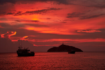 Fototapeta premium Fiery Sunset Trip with Boats and Island Silhouette (2)