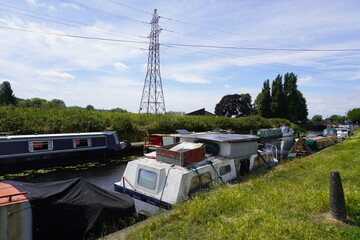 Nottinghamshire, England - June 20 2025: Peaceful canal scene with colorful boats, greenery, and...