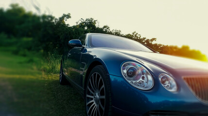 A luxury car parked in front of a modern mansion at sunset, showcasing elegance and opulence