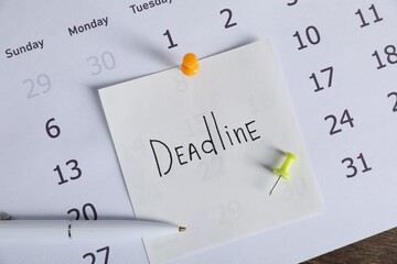 Sticky note with word Deadline, calendar and pen on table, top view