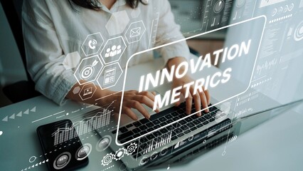 Business Professional Analyzing Innovation Metrics with Digital Interface Overlay on Laptop in Modern Work Environment. Asymptotic smart data analytic.