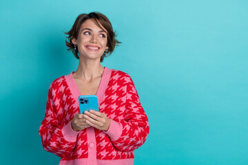 Photo of sweet dreamy lady wear red cardigan texting modern gadget looking emtpy space isolated...