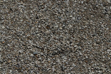 rocks and stones and pebbles texture. smooth pebbles background. variety of smooth, natural rocks with different shapes and textures. Processed collage of sea shore pebbles texture. 