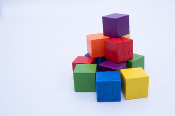 Obraz premium A Jumbled Pile of Brightly Colored Wooden Blocks on a Clean White Surface