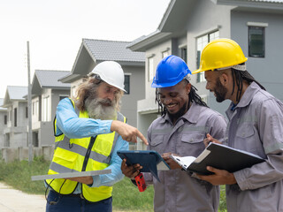 Professional architect and foreman wear head hat talk meeting safety work team check inspection...