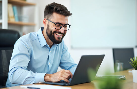 Bearded businessman works at laptop in office. Smiling male uses tech for online research, marketing, finance, accounting. Happy employee, digital nomad, entrepreneur, business person, typing emails.