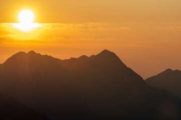 Sunrise on Augstmatthorn, painting the sky in gold above Brienzersee. A peaceful moment above the clouds, where silence meets breathtaking alpine beauty.
