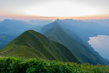 Sunrise on Augstmatthorn, painting the sky in gold above Brienzersee. A peaceful moment above the...