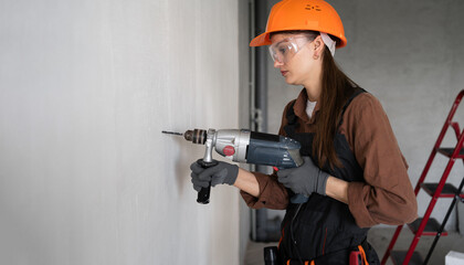 Female Construction Worker Drilling Wall at Home Wearing Hardhat During Renovation