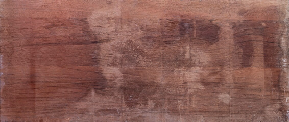 Aged mahogany wood surface with natural texture and weathered appearance