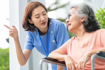 A female caregiver provides compassionate, patient-centric support to a senior woman. Concept for...