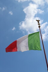 Italian flag in cloudy sky. waving in the sky. Italian flag in a wind on a cloudy blue sky background in Rome