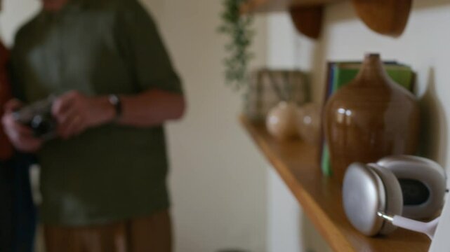 Picture of family of three in frame standing on wooden shelf and happy senior couple with smartphone watching online video or communicating with their children