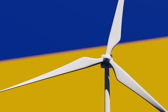 Wind turbine on a background of blurred flag of Ukraine. Wind power concept, selective focus