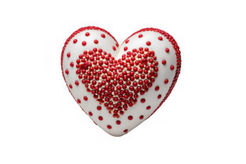 A white heart shaped confection decorated with red sprinkles and dots isolated on transparent background