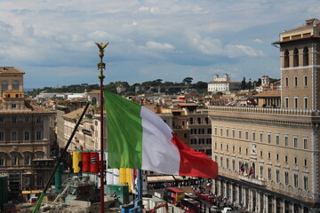 Italian flag waving in wind with Rome in Background 