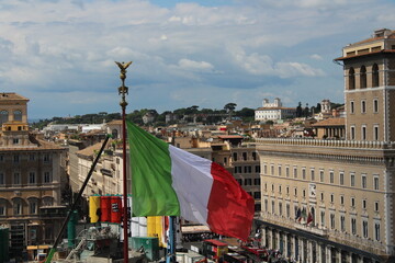 Italian flag waving in wind with Rome in Background 