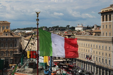 Italian flag waving in wind with Rome in Background 