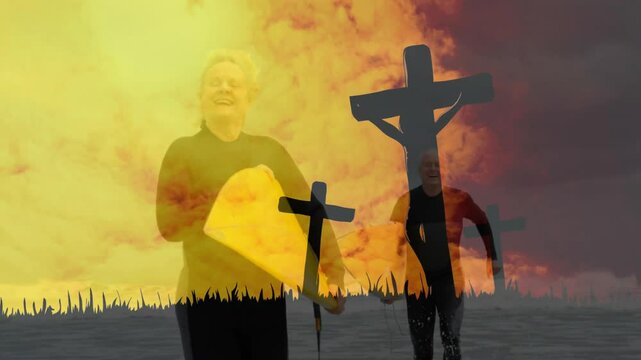 Leaving surf in sports, surfer couple walking toward shore carrying yellow surfboards by crosses