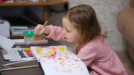Little girl painting with watercolors at home - Powered by Adobe