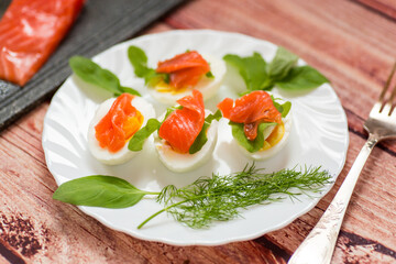 Cold festive appetizer of eggs with fish slices