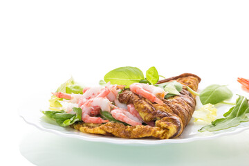 Fried omelette with shrimps and greens on a white background
