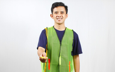 parking attendant wearing green vest giving ticket,isolated on white background