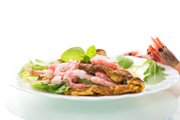 Delicious omelet with shrimps and fresh herbs on top, on a white background
