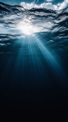 Obraz premium Sunlight shining through the water. The water is clear and blue. The sun is in the sky