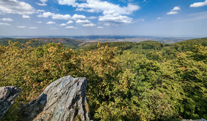 Dramatic view over hills and valleys, framed by rugged rocks. Captured at Látó-kövek viewpoint...