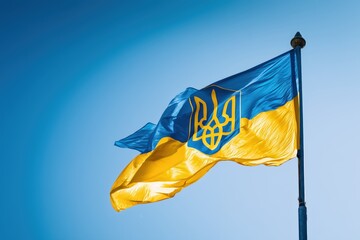 National flag of Ukraine waving proudly against a bright blue sky backdrop, symbolizing patriotism and national pride.