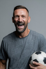 portrait of energetic physical education teacher on left side of frame holding ball