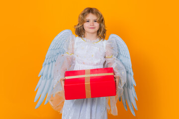 Angel child hold gift present. Valentines day. Little cupid angel child with wings. Studio portrait...