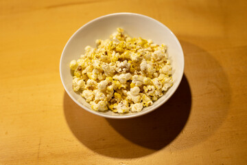 popcorn in a white plate on the table, movie time