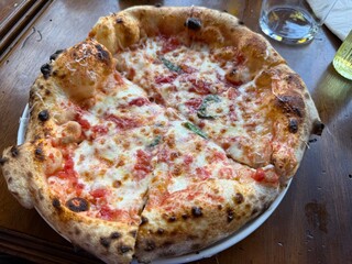 neapolitan homemade pizza margarita from the brick oven. Napoleon Italian Pizza with fresh mozzarella and basil leaves. true Italian Traditional Pizza Margherita
