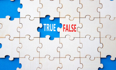 True or False symbol. Concept word True or False on wooden puzzle. Beautiful blue background....