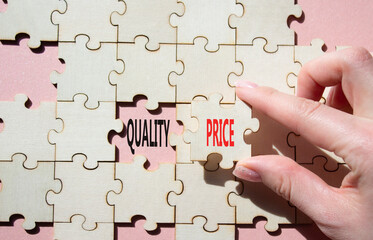 Price or Quality symbol. Concept word Price or Quality on wooden puzzle. Businessman hand....