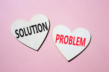 Solution vs Problem symbol. Concept word Solution vs Problem on wooden hearts. Beautiful pink...