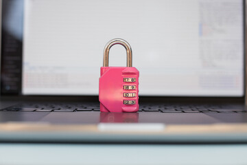 Data protection and strong password concept – pink lock on keyboard for secure online access....