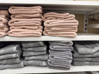 Stack of terry towels in different colors on shelf in store