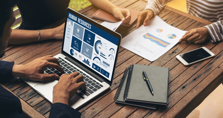 Human resources management software on computer screen helping human resources employee to manage...