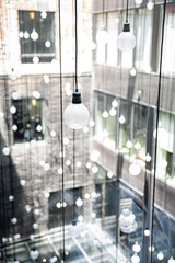 Modern Art Installation of Hanging Light Bulbs in Urban Courtyard

