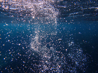 Light filtering down through blue water. Underwater sunlight in deep sea. Light viewed from blue...