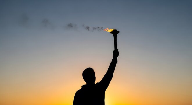 Silhouette of Person Holding a Burning Torch at Sunset Symbol of Hope and Perseverance