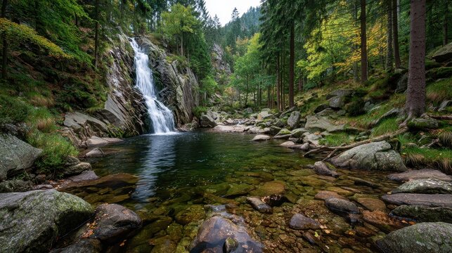 Serene waterfall flows into a calm pool in the black forest, baden-wurttemberg, germany