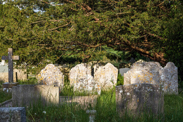 United Kingdom, Isle of Wight - 06.21.2025: Old gravestones in medieval overgrown and forgotten...