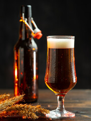 Cold beer glass on wooden table, beer bottle and wheat ears