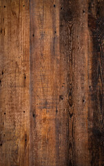 Obraz premium Brown wooden background texture highlighting the wood grain. Natural rustic backdrop depicting a surface comprising of slats of lumber.
